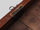 a wooden box with a pair of scissors inside of it
