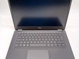 dell laptop computer with blue screen and keyboard on white surface