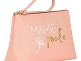a pink purse with gold lettering and a flower on it