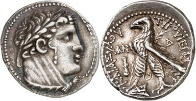 a silver coin with an image of a woman and a bird on it