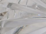 a close up picture of a glass vase with a toothbrush in it