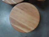 three wooden stools sitting on the floor next to each other