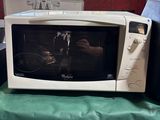 a microwave sitting on a table with a green table cloth