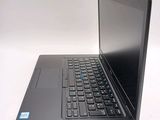 a laptop with a black keyboard on a white surface