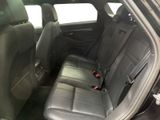 the back seats of a black car with a red seat belt