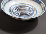 a blue and white plate with a fish design on it