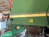 an image of a large green machine in a warehouse