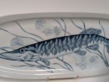a large platter with a fish painted on it