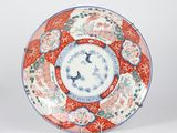 a red and blue plate with a floral design on it
