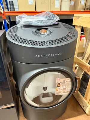 a black stove sitting next to a refrigerator in a store