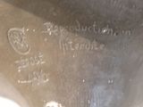 a close up of a metal object with writing on it