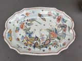 a plate with a floral design on it sitting on a table