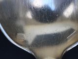 a close up of a spoon on a black surface