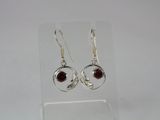 silver plated earrings with garnets and garnets on them