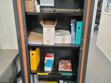 a bookcase with a bunch of boxes on top of it