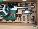 a box with a green and white machine inside of it