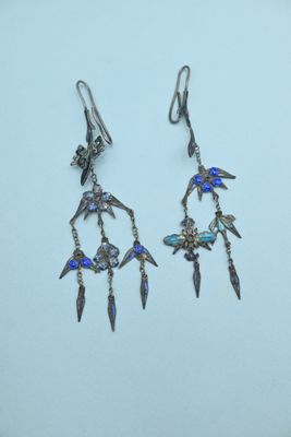 two pairs of earrings with blue glass beads hanging from them