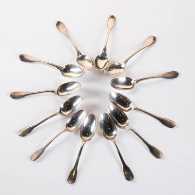 a lot of spoons arranged in a circle on the table