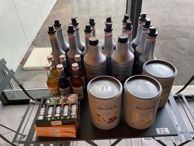 many cans of beer on a table with a lot of bottles