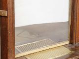 a wooden cabinet with a mirror on top of it