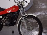 a red and black motorcycle parked in a parking garage