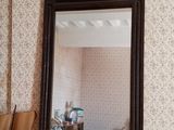 a mirror on a table with a hat on it