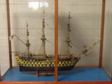 a display case with a model of a ship in it