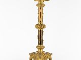 an image of a tall brass candle holder with a bird on it