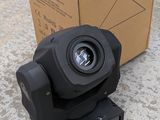 an image of a moving light sitting on top of a cardboard box