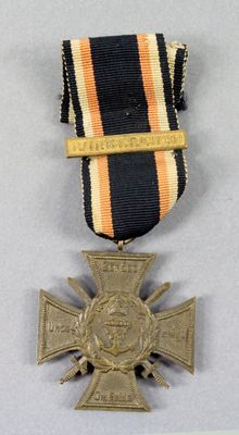 an image of a medal with a cross on it on a table
