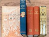 three books that are sitting on a wooden table
