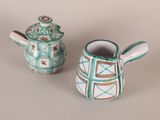 two teapots sitting next to each other on a table