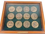 an image of a display case with twelve gold coins in it