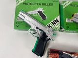 a gun and a cigarette sitting on a table