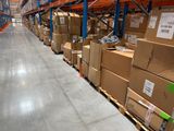 boxes are stacked on pallets in a large warehouse filled with pallets