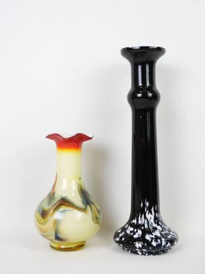 two vases sitting next to each other on a white surface