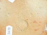 a close up of a brown vase with tags on it