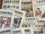 several newspapers are stacked on top of each other on the floor