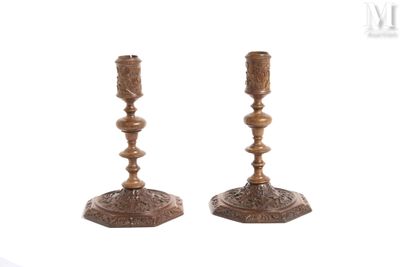 pair of antique brass candlesticks on a white background