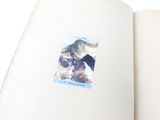 an open book with a picture of a mountain on it