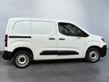 the white van is parked in a room with a gray floor