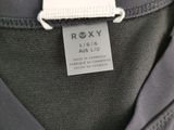 a close up of a gray jacket with a tag on it