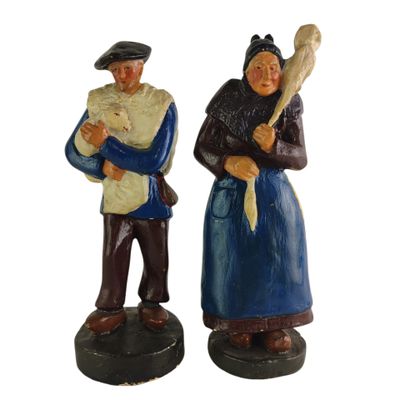 pair of figurines of two people holding a baseball bat and a ball