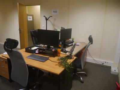 a desk with two computer monitors and a keyboard on it