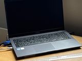 a laptop computer sitting on a desk next to a mouse