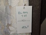 a label on the back of a dress with a price tag attached to it