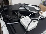 a laptop computer sitting on top of a desk with a lot of wires