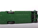 a green toy truck that is sitting on a white surface