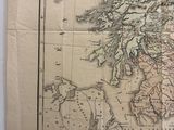 an old map of scotland on a piece of paper next to a pair of scissors