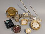a lot of clocks and other items on the table